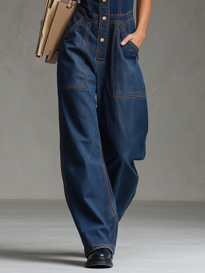 The Vintage Denim Jumpsuit by Mila and June — dark blue denim with multi-pocket utility styling and decorative topstitching